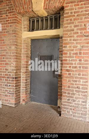 Heavy metal security door in brick wall, German facility Stock Photo