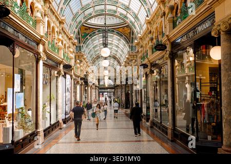 Shoppers walking through the ornate County Arcade in the Victoria Quarter, a luxury shopping destination in Leeds city centre, West Yorkshire, UK Stock Photo