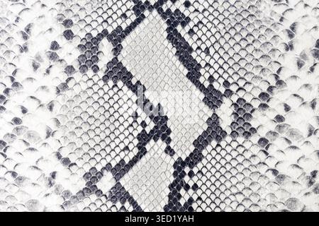 Textured python snake print on pure leather as background with copy space. Abstract empty soft snake leather texture sample. Stock Photo