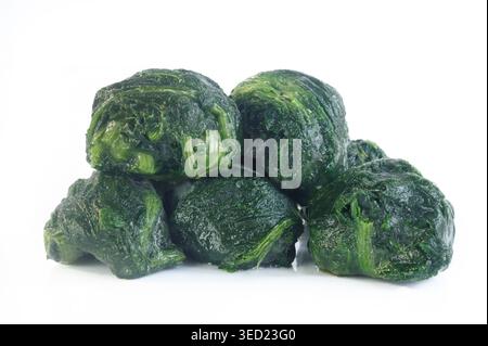 frozen spinach balls on white background Stock Photo