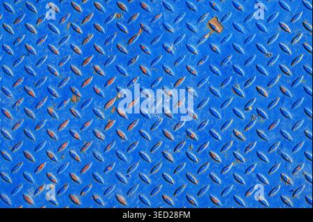 Close-up of textured blue diamond plate metal with signs of rust and wear Stock Photo