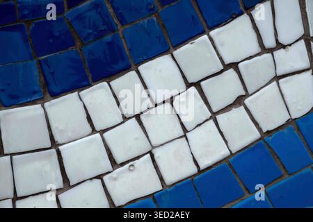 Blue and white ceramic mosaic tiles in a curved pattern Stock Photo