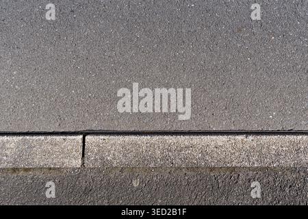 paved road surface and concrete curb Stock Photo