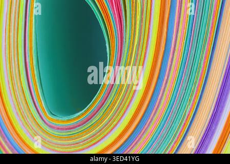 Rolled colorful paper sheets creating a vibrant abstract pattern and swirling layers Stock Photo