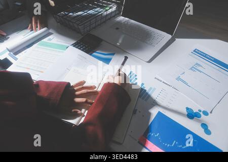 business people or accountant using calculator while working analytical business report on the workplace, accounting concept, Serious and focused fina Stock Photo