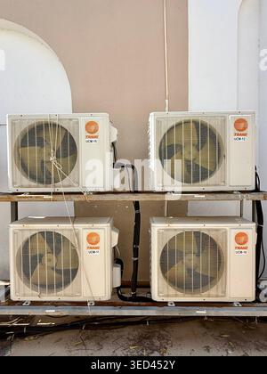 Multiple air-conditioning units installed on a building exterior in Mérida, Mexico, reflecting rising cooling demand in a warming urban climate. Stock Photo