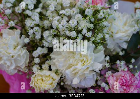 Flowers arranged in a bouquet with white and pink blooms in a simple setting Stock Photo