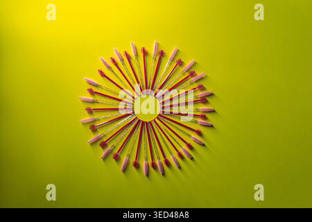 Many brow brushes are placed in a circular pattern on a vibrant green surface The brushes have various colors and designs They create a visual display Stock Photo