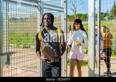 Diverse friends entering pickleball court ready for game Stock Photo
