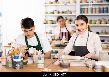 Young woman and young man making pottery Stock Photo