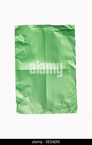 Green crumpled paper sheet texture, creased and folded, blank surface material with natural wrinkles and copy space, white background Stock Photo