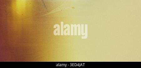 Abstract brownish yellow gradient creating a retro background with soft focus and visible film grain texture Stock Photo