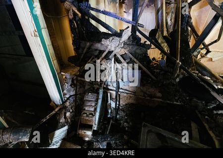 Damaged house interior, aftermath of explosion and fire after attack. Stock Photo