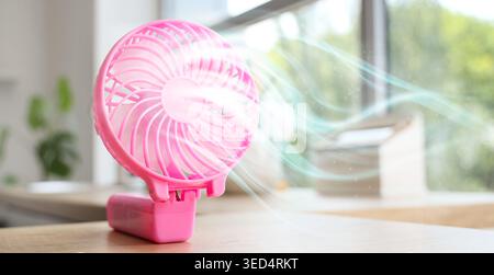Pink mini fan on table, closeup Stock Photo