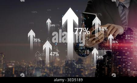 Business Person Analyzing Financial Growth Trends with Smartphone in Urban Night Scene Featuring Graphs and Upward Arrows for Success and Progress Stock Photo