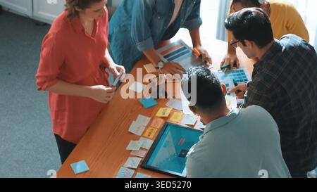 Top view of manager writing idea on sticky notes and explain idea about web design. Professional marketing team or programmer brainstorming idea while Stock Photo