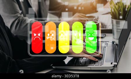 Emotion Indicator on Laptop Screen Showing Various Expressions with Colorful Battery Levels Representing Different Feelings in a Modern Office Setting Stock Photo