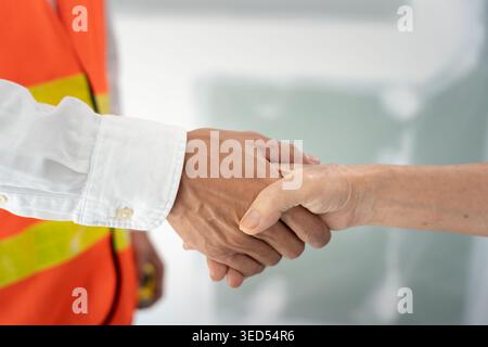 Construction team hands shaking greeting start up plan new project contract in office center at construction site, industry ,architecture, partner, te Stock Photo