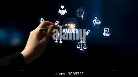 Hand Holding Pen Pointing at Core Values Icons on a Digital Screen Representing Business Principles and Ethical Standards in Corporate Environment Stock Photo
