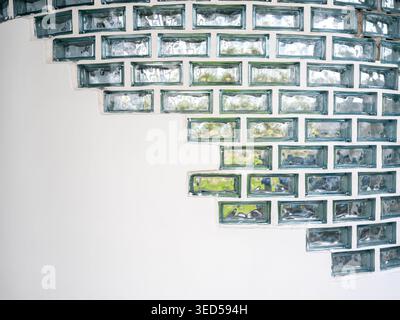 Glass block curved wall pattern with geometric arrangement on white background, modern architectural texture design, abstract minimal backdrop for int Stock Photo