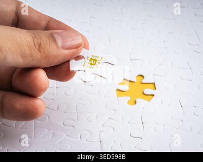 Hand placing AI puzzle piece into missing spot on white jigsaw background. Artificial intelligence solving problems, innovation, business solution, te Stock Photo