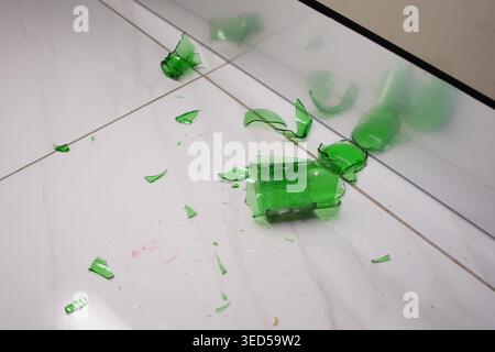 Shattered green bottles on a clean floor Stock Photo