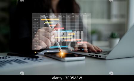 A business professional engages with digital tools to develop a project timeline. The modern office setting fosters productivity and effective Stock Photo