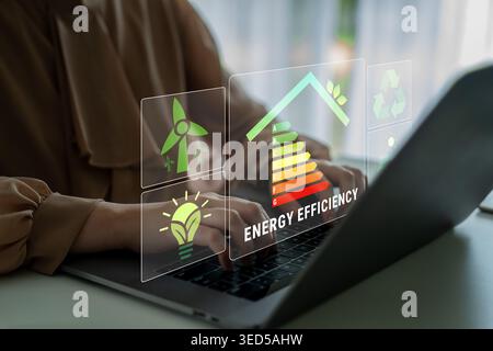 Woman Using Laptop with Energy Efficiency Graphics and Icons for Sustainable Practices and Green Technology in Modern Workspace Quark. Stock Photo