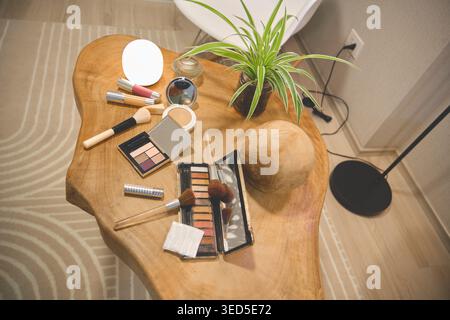 Various beauty products and a green plant creating a self-care and wellness mood Stock Photo