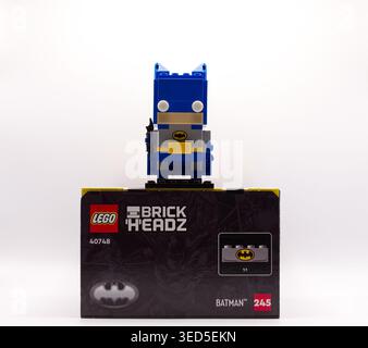 Blue batman lego brickheadz construction toy figure standing on top of its original packaging box over white background Stock Photo