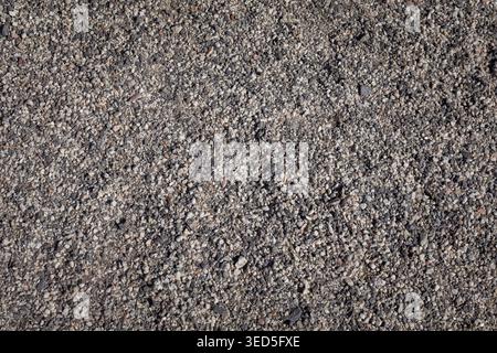 Texture of the street pavement of tracks made of rubber granular crumb. Granulate close-up. Stock Photo