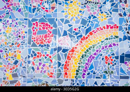 Colorful abstract ceramic mosaic. Close up. Mosaic on the wall with fragments of blue, white, black colors with pieces. Stock Photo