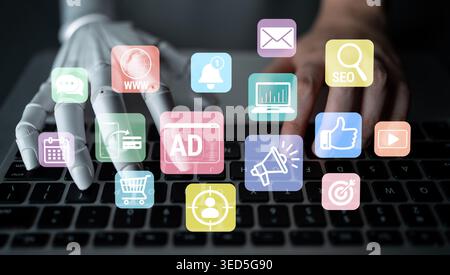 Human-like robotic hand interacting with digital marketing icons on laptop keyboard showcasing advancements in technology and online advertisement Stock Photo