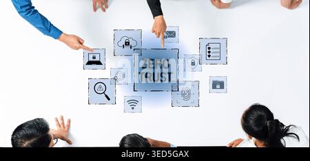 A group of professionals collaborates on a zero trust security concept, analyzing various digital icons on a workspace, emphasizing protection and Stock Photo