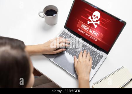 Virus warning alert on computer screen detected brisk cyber threat , hacker, computer virus and malware Stock Photo