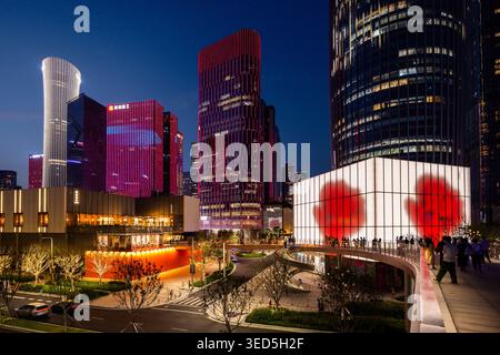 Shenzhen Bay towers and luxury retail MixC shopping centre, near Houhai Station at night, during an evening light show Stock Photo