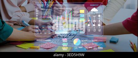 Collaborative Business Team Analyzing Data and Creating Visual Reports on a Modern Digital Interface during a Meeting Fluxor. Stock Photo