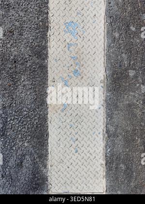 Diamond Plate Metal Insert in Asphalt, Industrial Top Down Texture Background Stock Photo