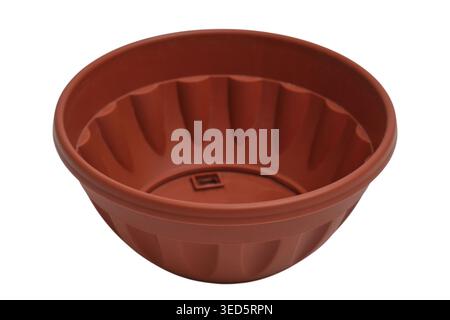 Empty brown plastic flower pot for indoor gardening. Rounded garden planter isolated on white background. Ornamental plant container for home decorati Stock Photo