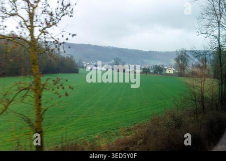 Foggy countryside landscape seen from train window with motion blur. Stock Photo