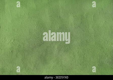 Background of a lime green stucco coated and painted exterior, rough cast of cement and concrete wall texture, decorative coating Stock Photo