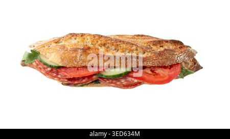Fresh baked baguette filled with sliced salami, cucumber, tomato, arugula leaves isolated on white background. Fresh crusty baguette submarine sandwic Stock Photo