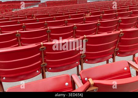 Rows of Empty Red Seats in Outdoor Amphitheater, Ready for an Audience Stock Photo