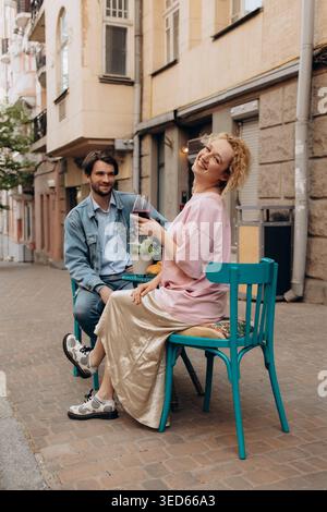 Happy Young Woman Drinking Red Wine at Outdoor Cafe Stock Photo