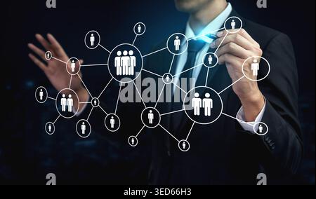 A business professional illustrates digital connections in a network, highlighting interaction and communication among individuals in a corporate Stock Photo