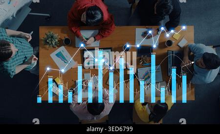 A group of professionals collaborates in a modern office, analyzing various data insights through charts and graphs. The atmosphere fosters teamwork Stock Photo