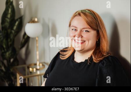 Smiling woman in black top with lifestyle indoor background Stock Photo