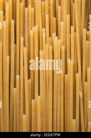 Close up of dry uncooked spaghetti noodles filling frame. Stock Photo
