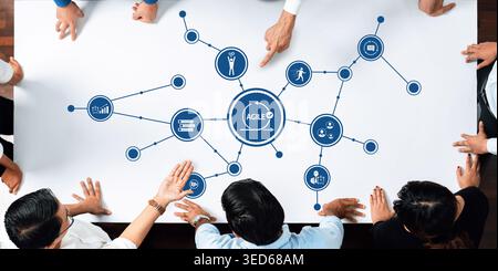 A group of diverse professionals engages in an interactive discussion around a table, visualizing an agile workflow and various business concepts to Stock Photo