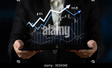 A business professional displays a tablet showing dynamic graphs that indicate financial growth, performance metrics, and trends, symbolizing success Stock Photo